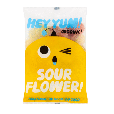 Organski gumeni bomboni HEY YUM! Sour Flower u veseloj žutoj ambalaži s crtanim likom
