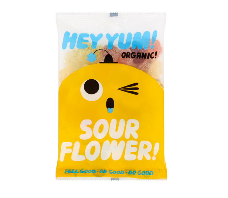 Organski gumeni bomboni HEY YUM! Sour Flower u veseloj žutoj ambalaži s crtanim likom