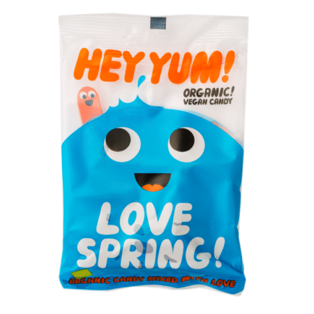 Pakiranje organskih veganskih bombona Hey Yum! Love Spring s plavim nasmijanim likom