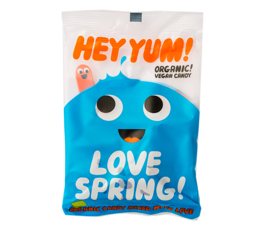 Pakiranje organskih veganskih bombona Hey Yum! Love Spring s plavim nasmijanim likom
